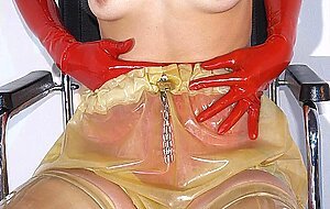 Solo girl attends to her horny cunt with stainless steel devices in latex wear